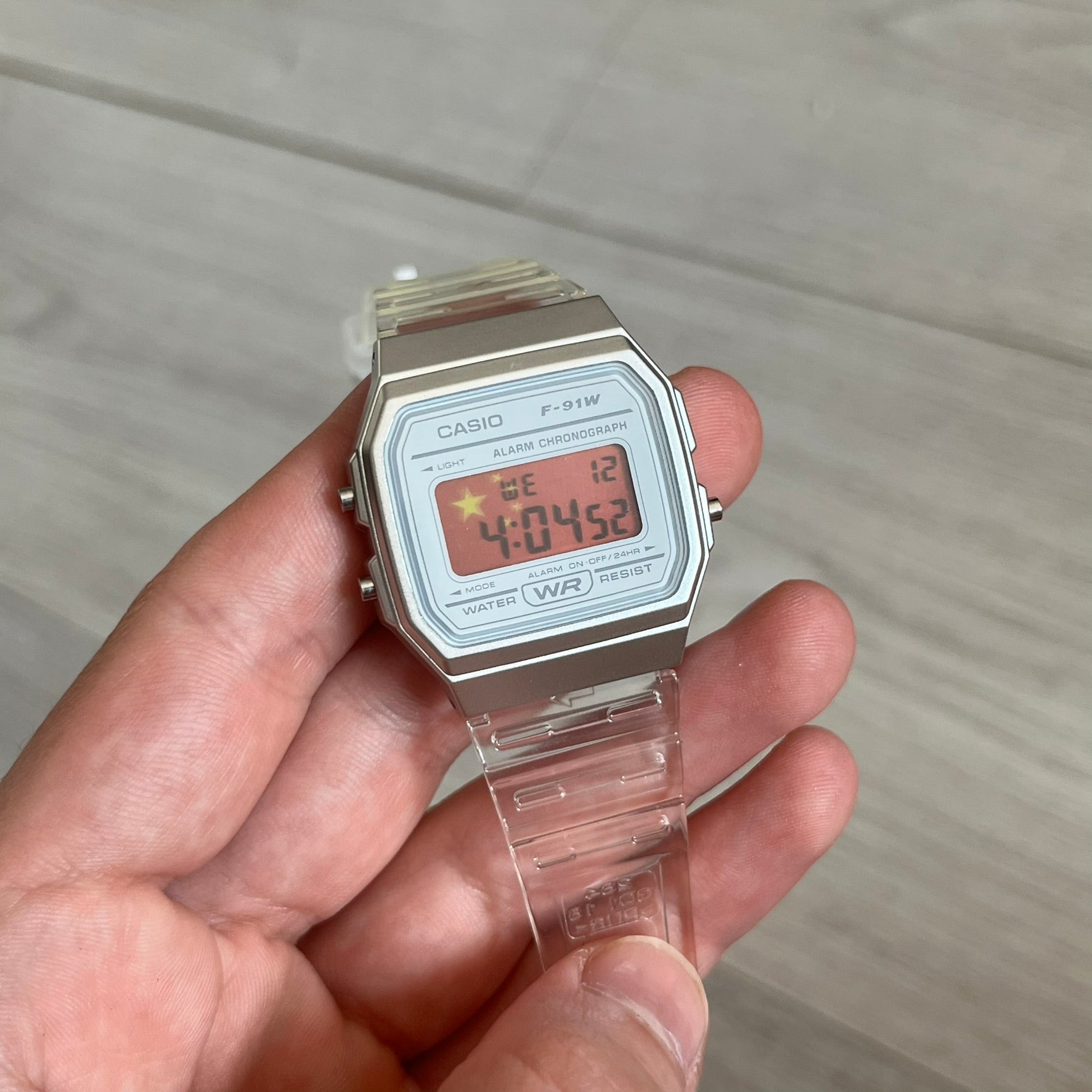 Custom Casio F-91W Clear/Transparent digital watch featuring a China Flag filter screen. Slim 8.5 mm profile, lightweight 21 g build and flexible bio-based resin band ensure lasting comfort. Includes alarm, stopwatch, and microlight function for everyday functionality.