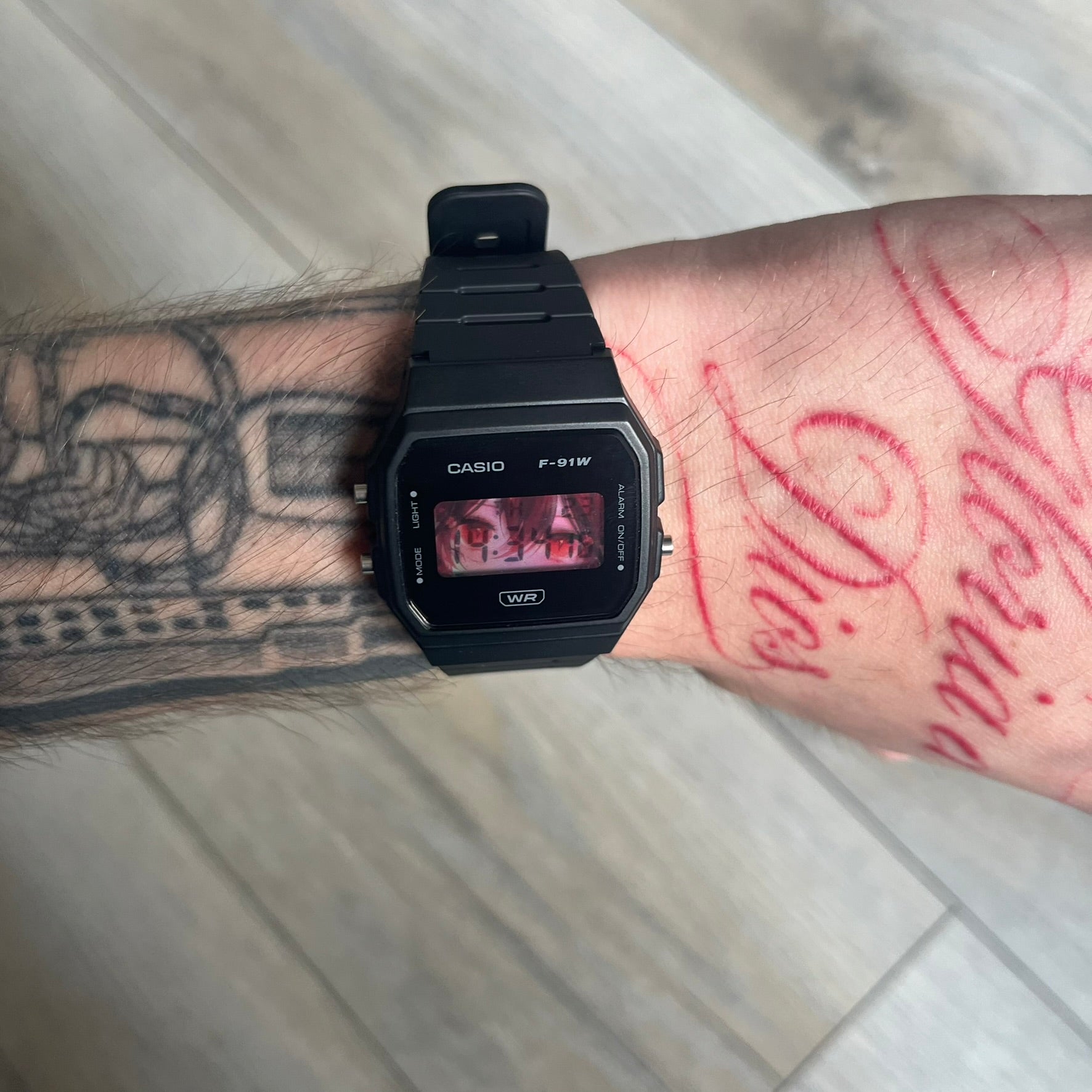 Custom Casio F-91W Black digital watch featuring a Anime red eyes filter screen. Slim 8.5 mm profile, lightweight 21 g build and flexible bio-based resin band ensure lasting comfort. Includes alarm, stopwatch, and microlight function for everyday functionality.
