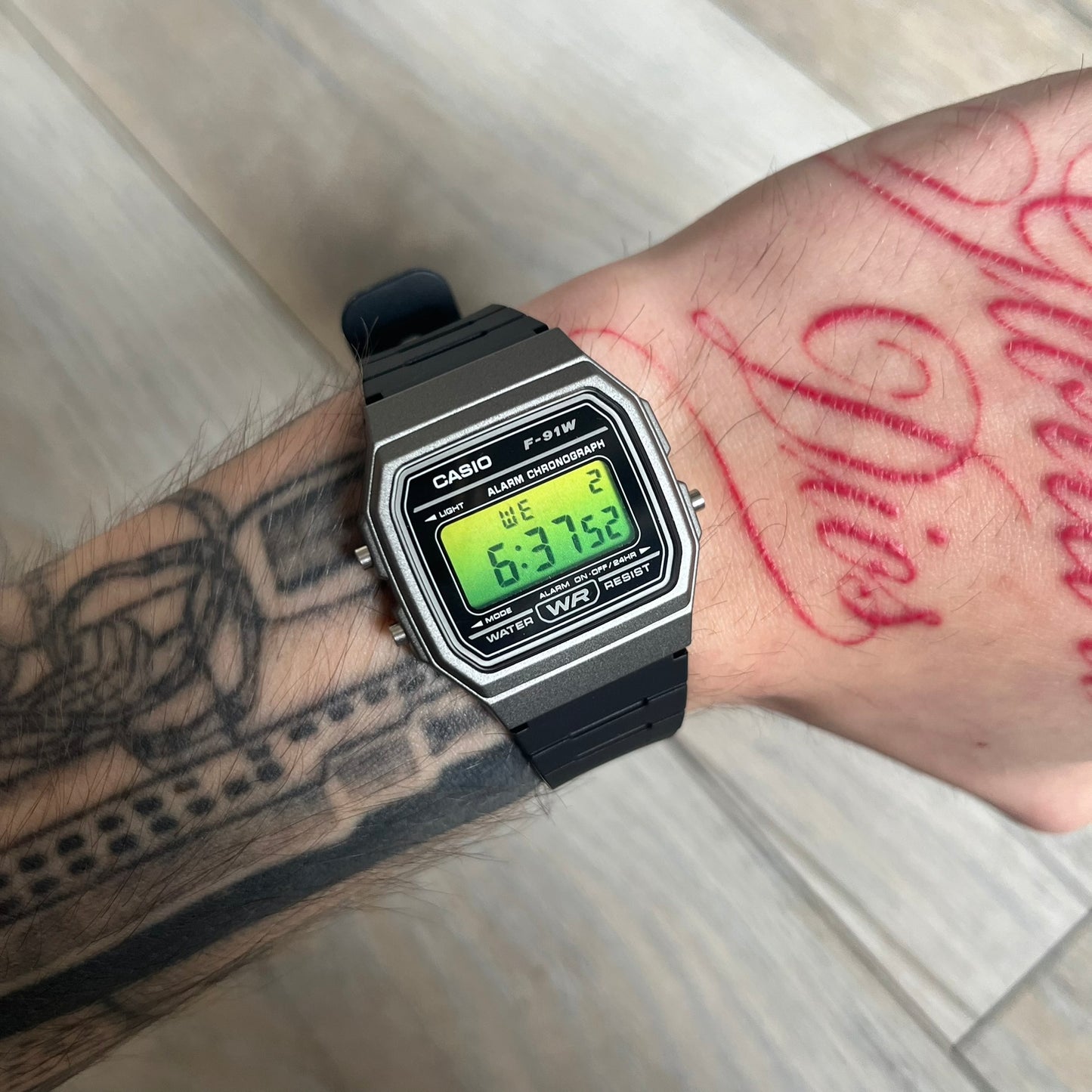 Custom Casio F-91W Black and silver digital watch featuring a Green gradient filter screen. Slim 8.5 mm profile, lightweight 21 g build and flexible bio-based resin band ensure lasting comfort. Includes alarm, stopwatch, and microlight function for everyday functionality.