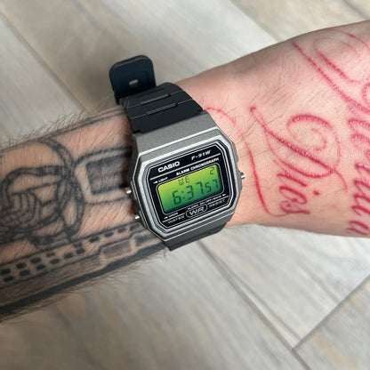 Custom Casio F-91W Black and silver digital watch featuring a Green gradient filter screen. Slim 8.5 mm profile, lightweight 21 g build and flexible bio-based resin band ensure lasting comfort. Includes alarm, stopwatch, and microlight function for everyday functionality.
