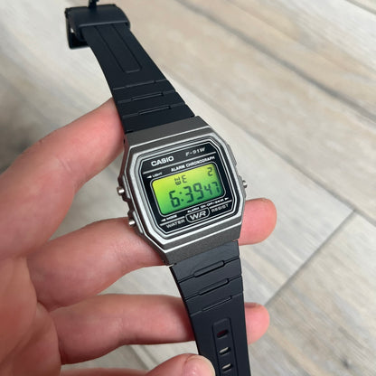 Custom Casio F-91W Black and silver digital watch featuring a Green gradient filter screen. Slim 8.5 mm profile, lightweight 21 g build and flexible bio-based resin band ensure lasting comfort. Includes alarm, stopwatch, and microlight function for everyday functionality.