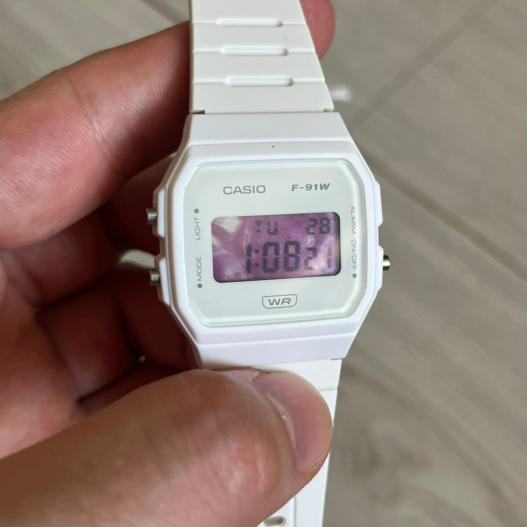 Custom Casio F-91W White digital watch featuring a Purple drink filter screen. Slim 8.5 mm profile, lightweight 21 g build and flexible bio-based resin band ensure lasting comfort. Includes alarm, stopwatch, and microlight function for everyday functionality.