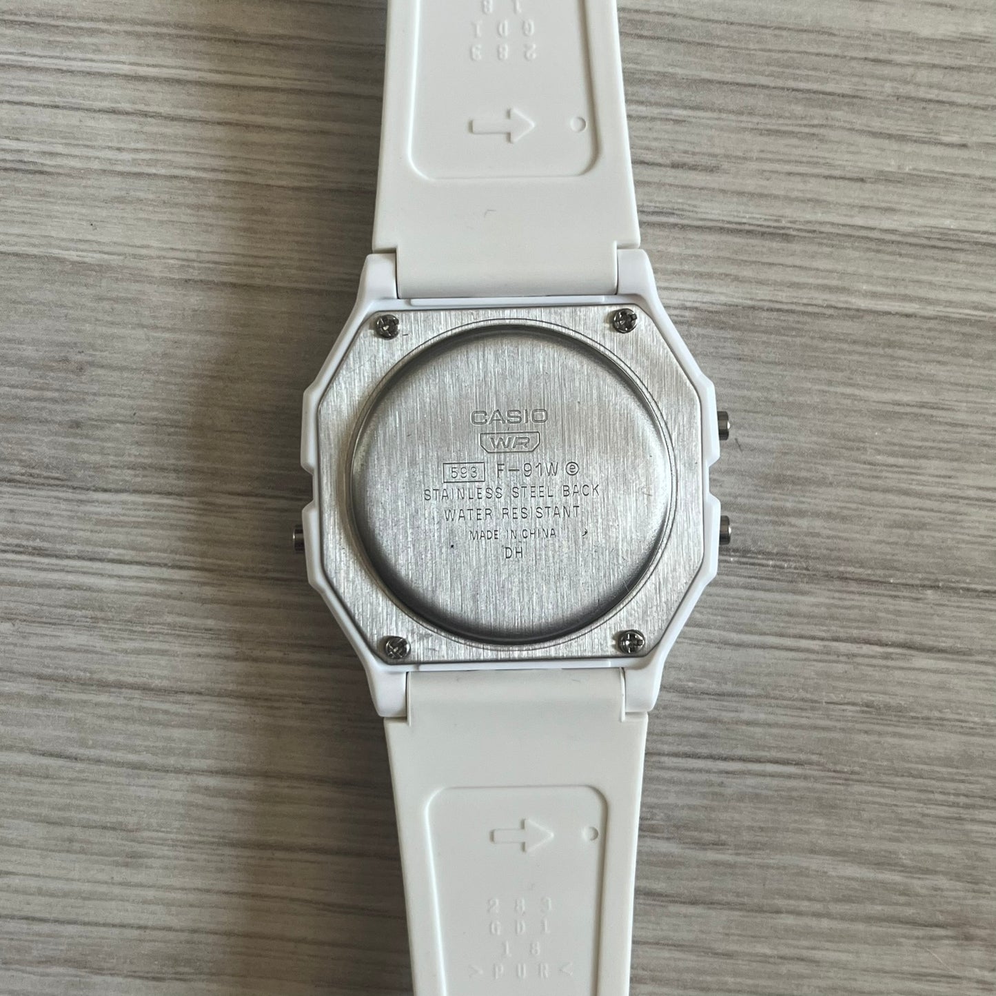 Custom Casio F-91W White digital watch featuring a Purple drink filter screen. Slim 8.5 mm profile, lightweight 21 g build and flexible bio-based resin band ensure lasting comfort. Includes alarm, stopwatch, and microlight function for everyday functionality.
