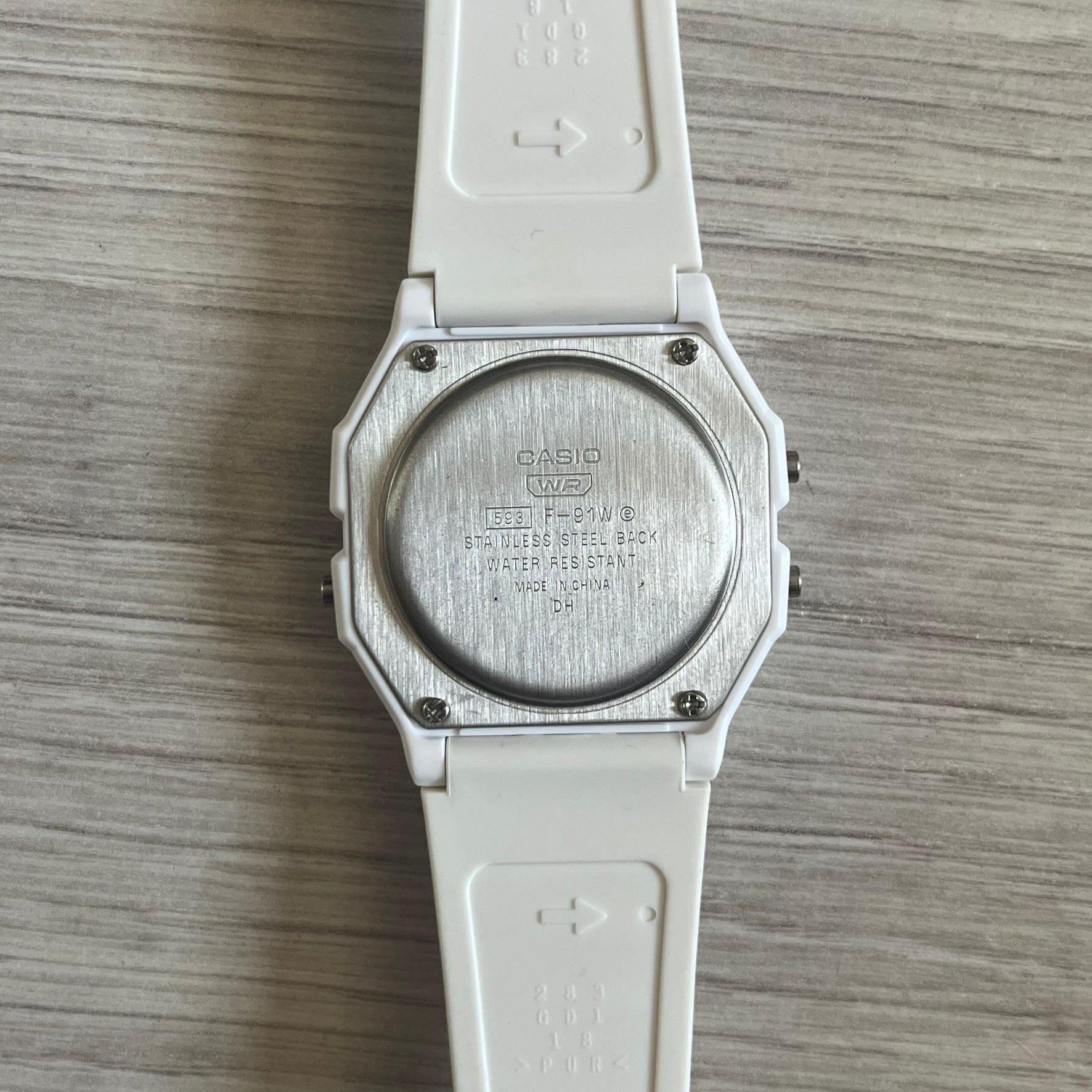 Custom Casio F-91W White digital watch featuring a Purple drink filter screen. Slim 8.5 mm profile, lightweight 21 g build and flexible bio-based resin band ensure lasting comfort. Includes alarm, stopwatch, and microlight function for everyday functionality.