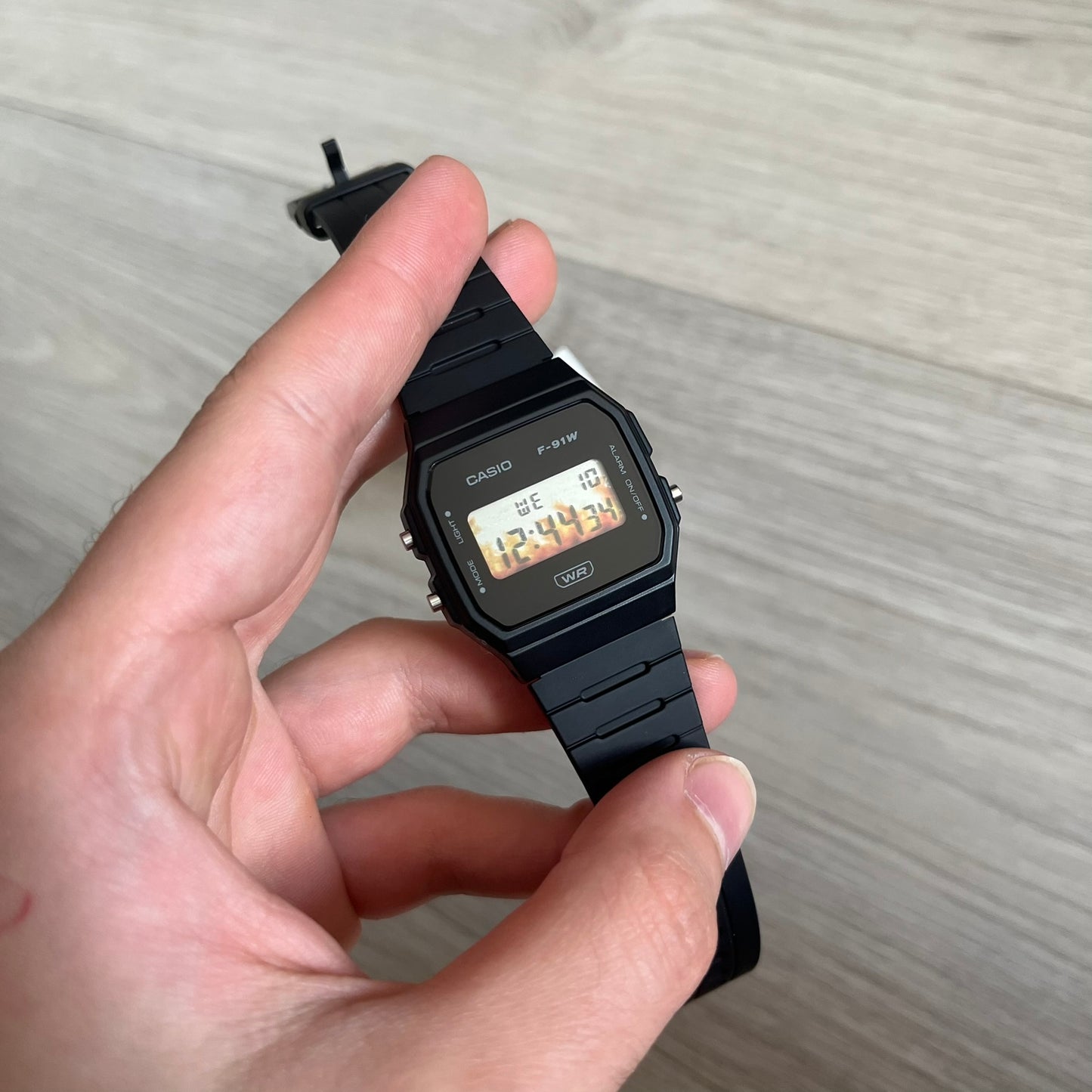 Custom Casio F-91W Black digital watch featuring a Flame filter screen. Slim 8.5 mm profile, lightweight 21 g build and flexible bio-based resin band ensure lasting comfort. Includes alarm, stopwatch, and microlight function for everyday functionality.