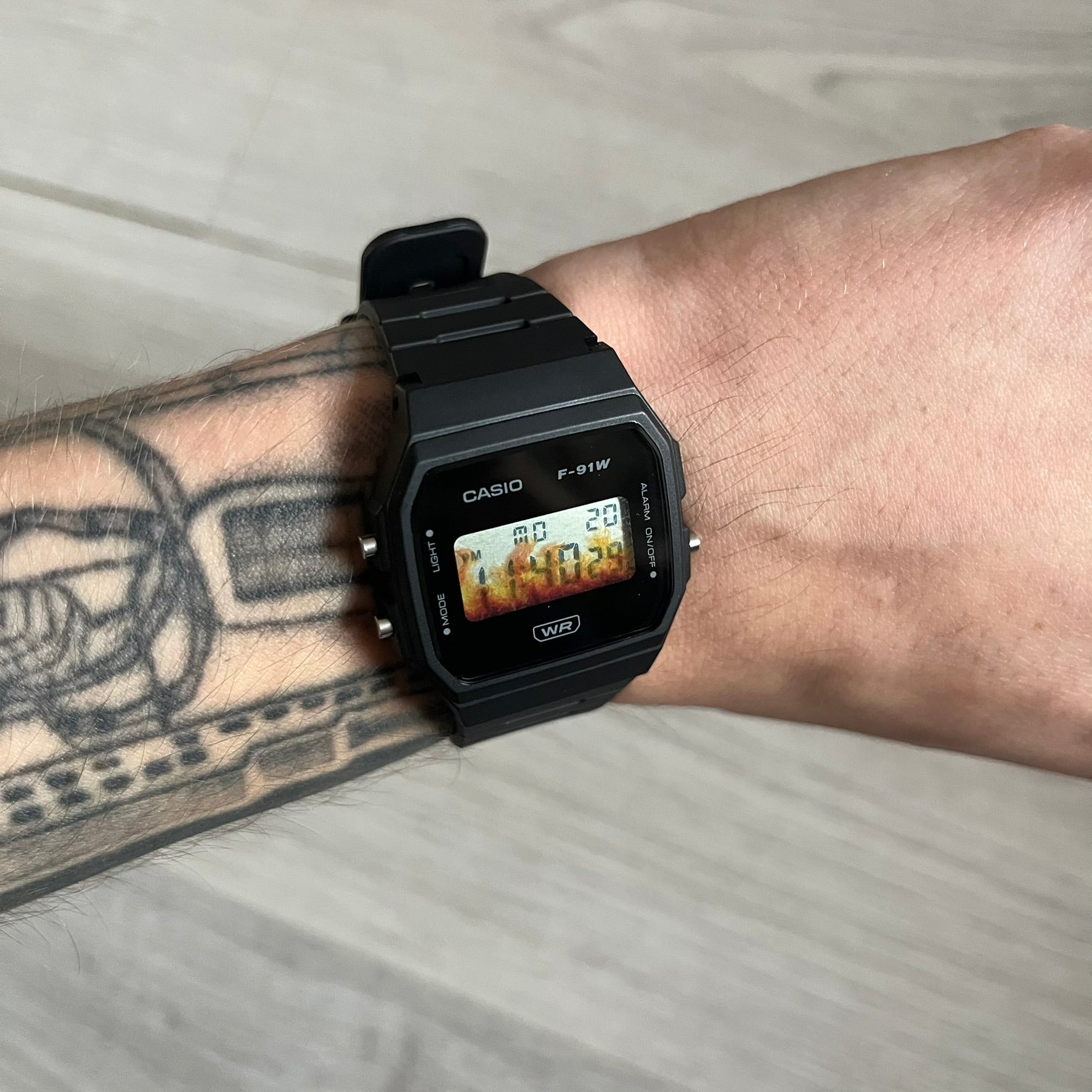 Custom Casio F-91W Black digital watch featuring a Flame filter screen. Slim 8.5 mm profile, lightweight 21 g build and flexible bio-based resin band ensure lasting comfort. Includes alarm, stopwatch, and microlight function for everyday functionality.
