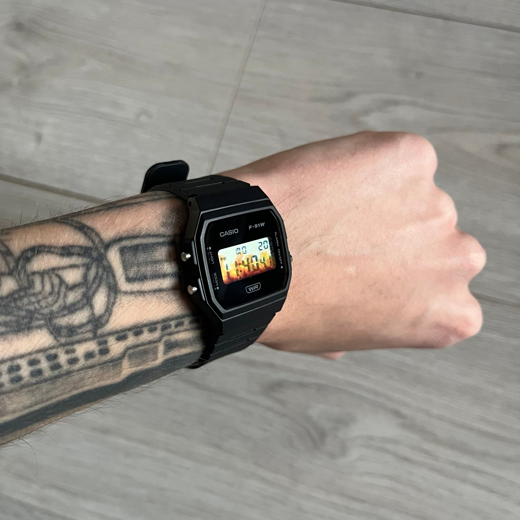 Custom Casio F-91W Black digital watch featuring a Flame filter screen. Slim 8.5 mm profile, lightweight 21 g build and flexible bio-based resin band ensure lasting comfort. Includes alarm, stopwatch, and microlight function for everyday functionality.