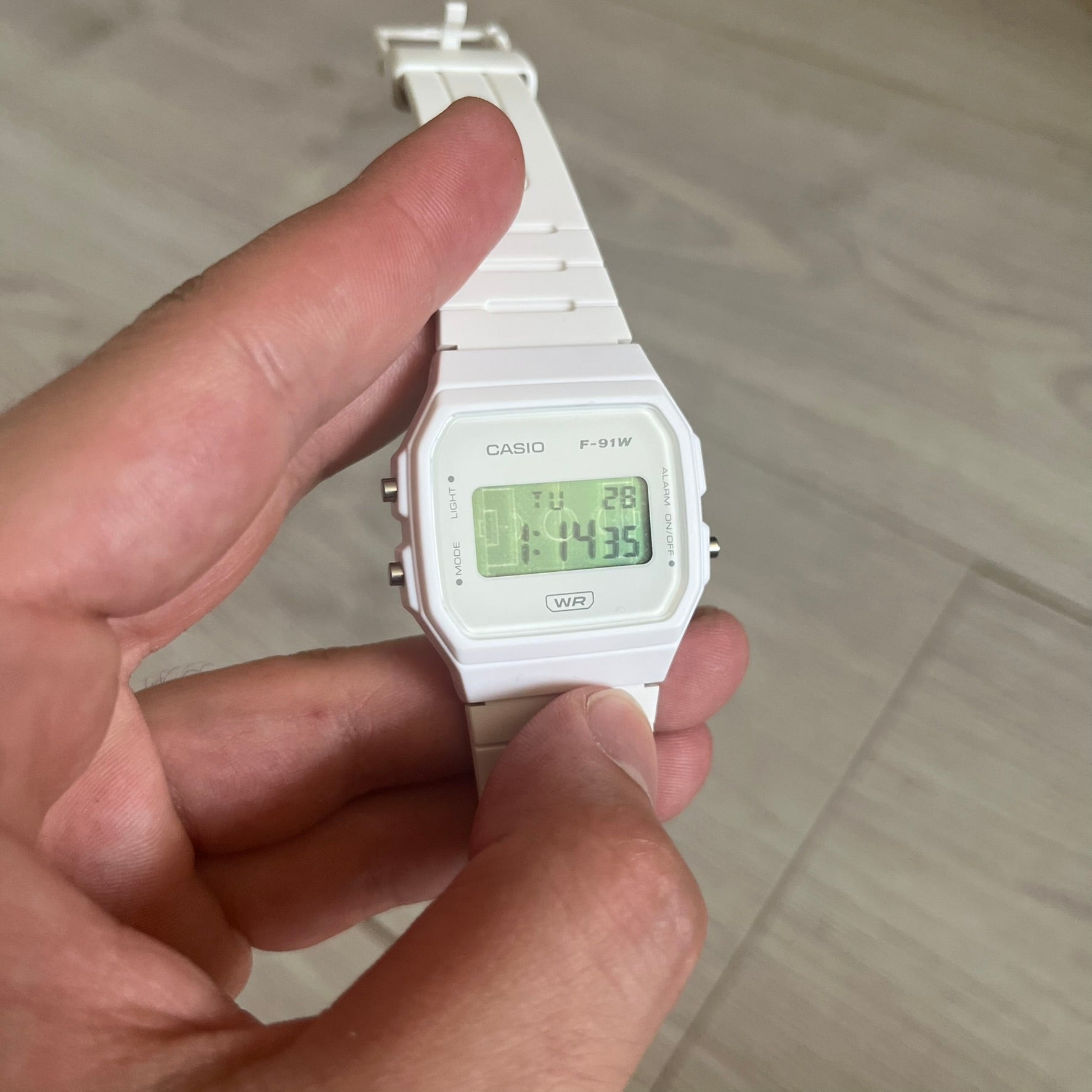 Custom Casio F-91W White digital watch featuring a Green Football Pitch filter screen. Slim 8.5 mm profile, lightweight 21 g build and flexible bio-based resin band ensure lasting comfort. Includes alarm, stopwatch, and microlight function for everyday functionality.