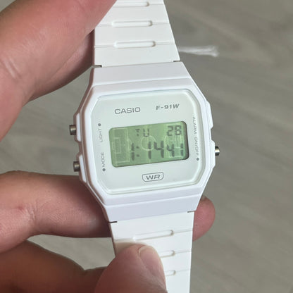 Custom Casio F-91W White digital watch featuring a Green Football Pitch filter screen. Slim 8.5 mm profile, lightweight 21 g build and flexible bio-based resin band ensure lasting comfort. Includes alarm, stopwatch, and microlight function for everyday functionality.