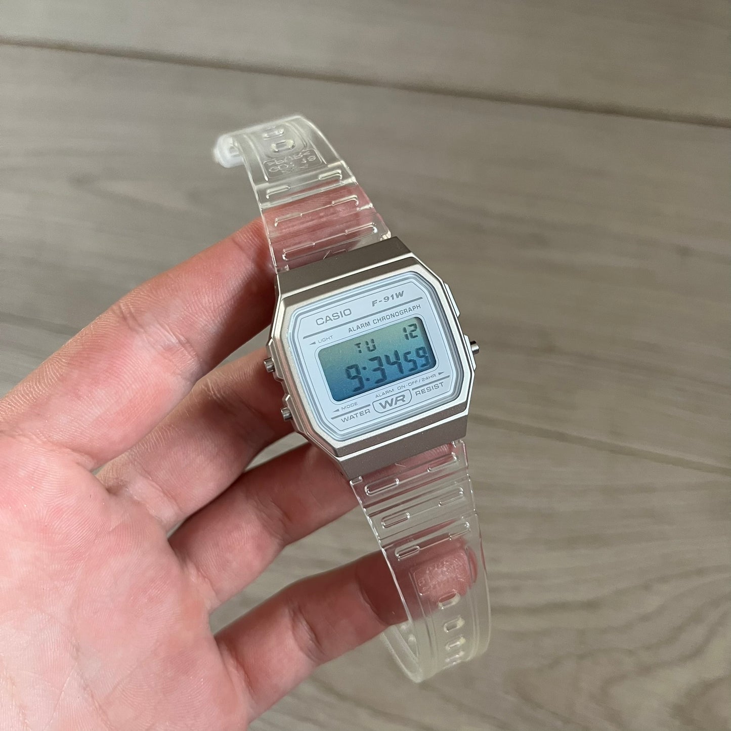 Custom Casio F-91W Clear/Transparent digital watch featuring a Gradient Blue filter screen. Slim 8.5 mm profile, lightweight 21 g build and flexible bio-based resin band ensure lasting comfort. Includes alarm, stopwatch, and microlight function for everyday functionality.