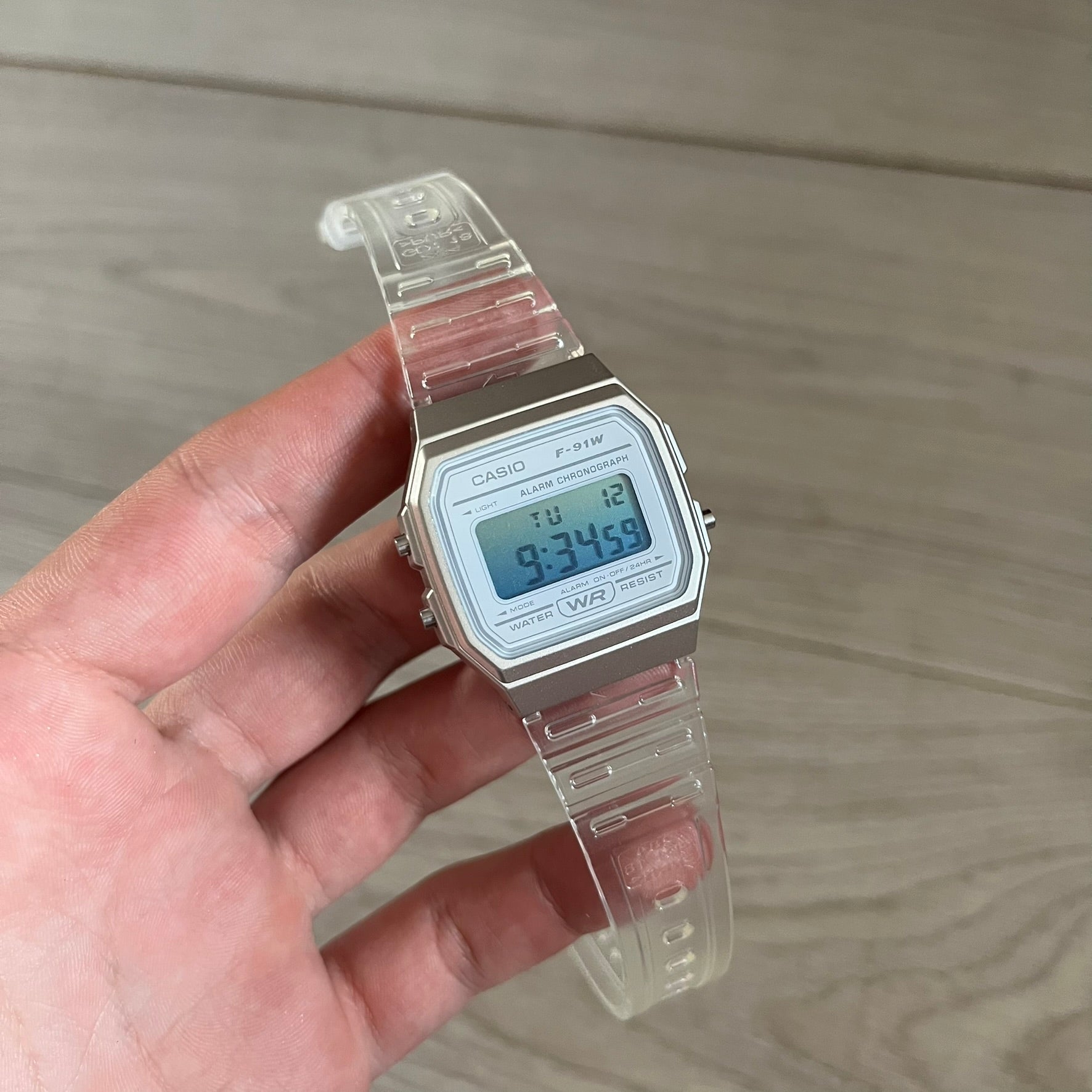 Custom Casio F-91W Clear/Transparent digital watch featuring a Gradient Blue filter screen. Slim 8.5 mm profile, lightweight 21 g build and flexible bio-based resin band ensure lasting comfort. Includes alarm, stopwatch, and microlight function for everyday functionality.