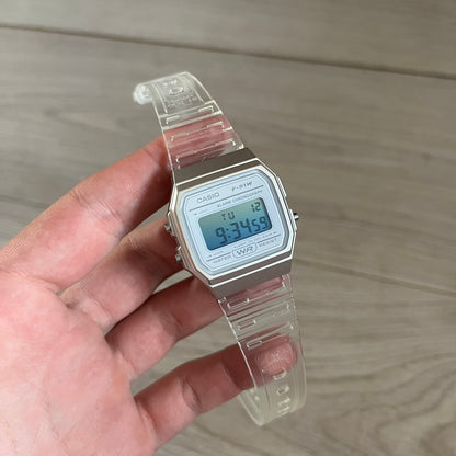 Custom Casio F-91W Clear/Transparent digital watch featuring a Gradient Blue filter screen. Slim 8.5 mm profile, lightweight 21 g build and flexible bio-based resin band ensure lasting comfort. Includes alarm, stopwatch, and microlight function for everyday functionality.