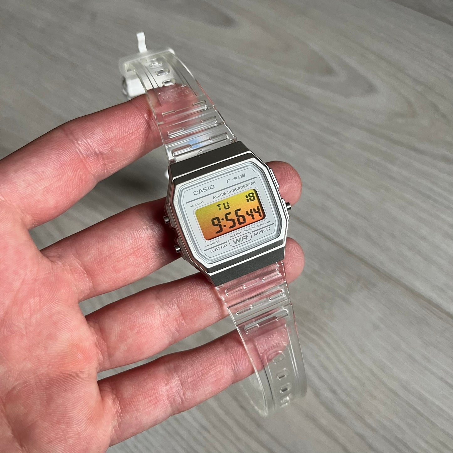 Custom Casio F-91W Clear/Transparent digital watch featuring a Yellow gradient. Slim 8.5 mm profile, lightweight 21 g build and flexible bio-based resin band ensure lasting comfort. Includes alarm, stopwatch, and microlight function for everyday functionality.