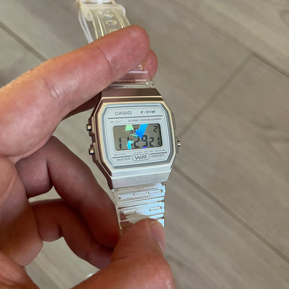 Custom Casio F-91W Clear/Transparent digital watch featuring a Holographic diamonds filter screen. Slim 8.5 mm profile, lightweight 21 g build and flexible bio-based resin band ensure lasting comfort. Includes alarm, stopwatch, and microlight function for everyday functionality.