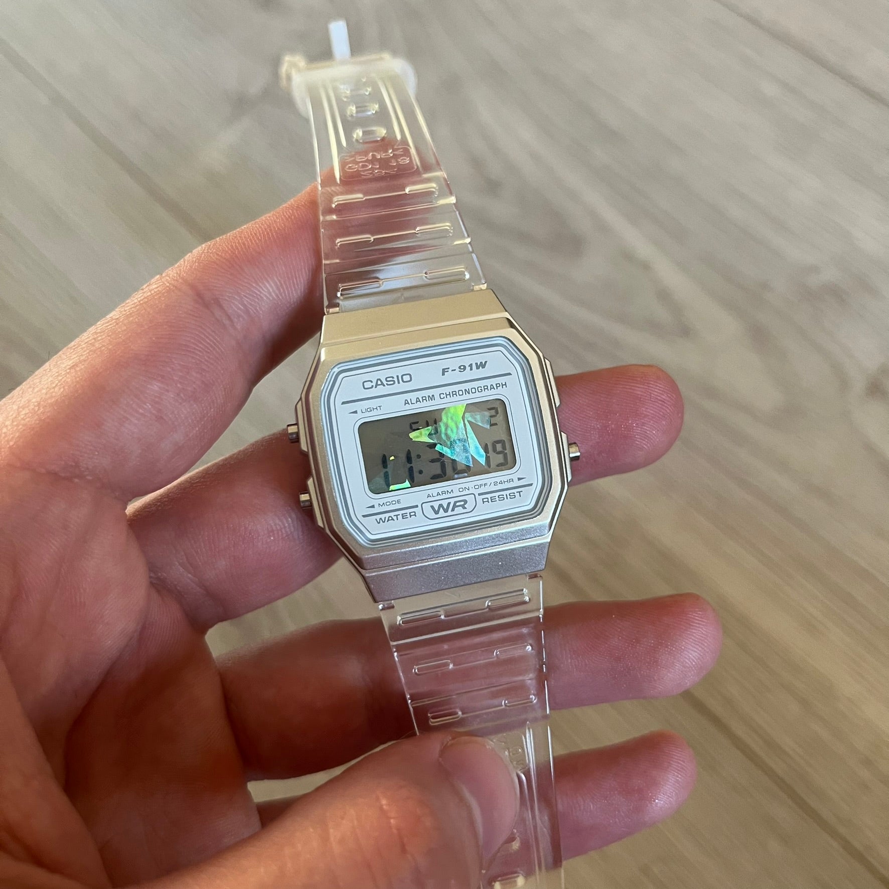 Custom Casio F-91W Clear/Transparent digital watch featuring a Holographic diamonds filter screen. Slim 8.5 mm profile, lightweight 21 g build and flexible bio-based resin band ensure lasting comfort. Includes alarm, stopwatch, and microlight function for everyday functionality.