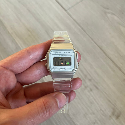 Custom Casio F-91W Clear/Transparent digital watch featuring a Holographic stars filter screen. Slim 8.5 mm profile, lightweight 21 g build and flexible bio-based resin band ensure lasting comfort. Includes alarm, stopwatch, and microlight function for everyday functionality.