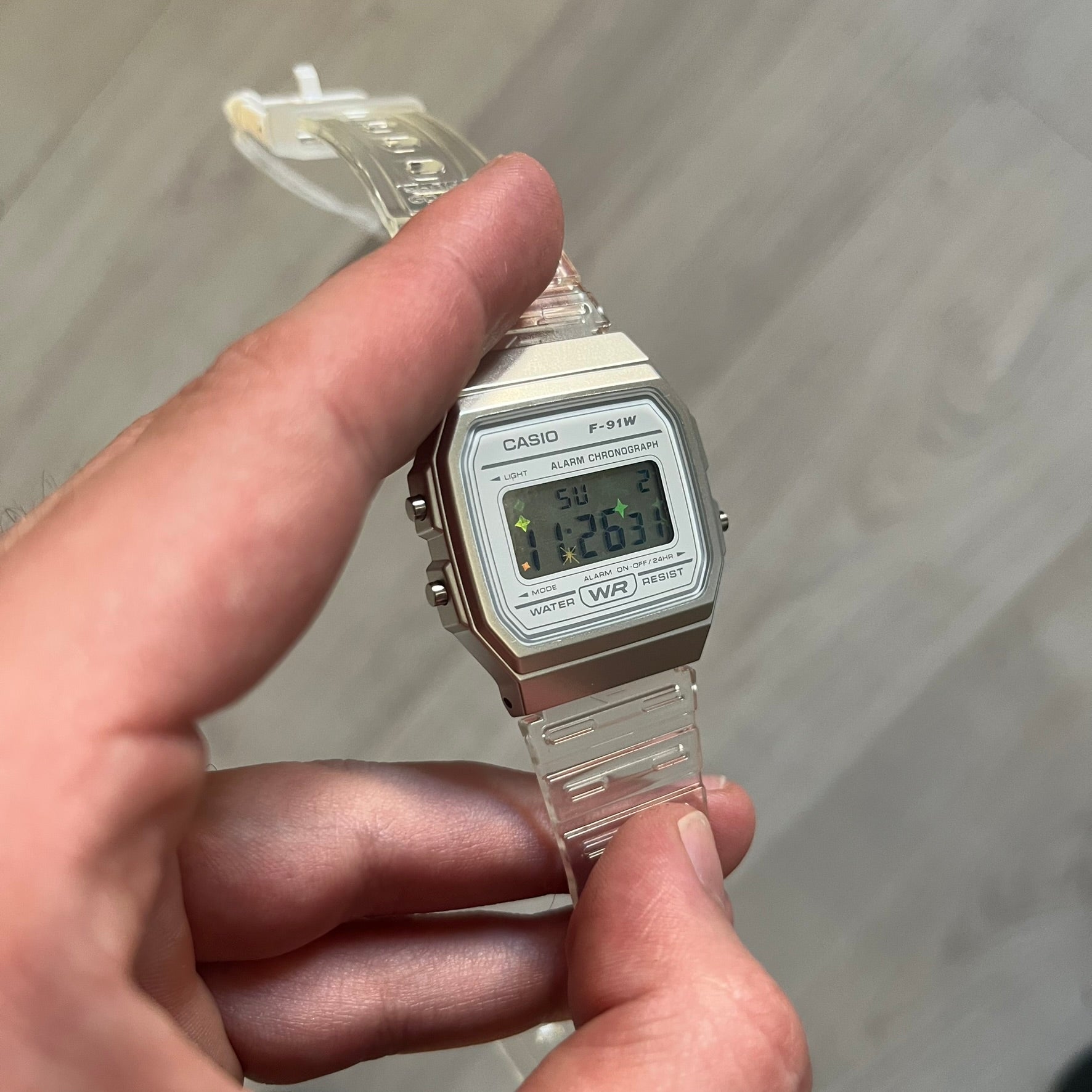 Custom Casio F-91W Clear/Transparent digital watch featuring a Holographic stars filter screen. Slim 8.5 mm profile, lightweight 21 g build and flexible bio-based resin band ensure lasting comfort. Includes alarm, stopwatch, and microlight function for everyday functionality.
