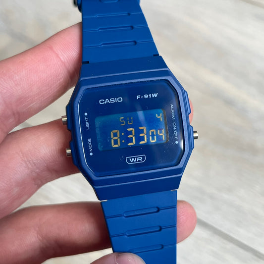 Custom Casio F-91W Dark blue digital watch featuring a matching Inverted Blue filter screen. Slim 8.5 mm profile, lightweight 21 g build and flexible resin band ensure lasting comfort. Includes alarm, stopwatch, and microlight function for everyday functionality.