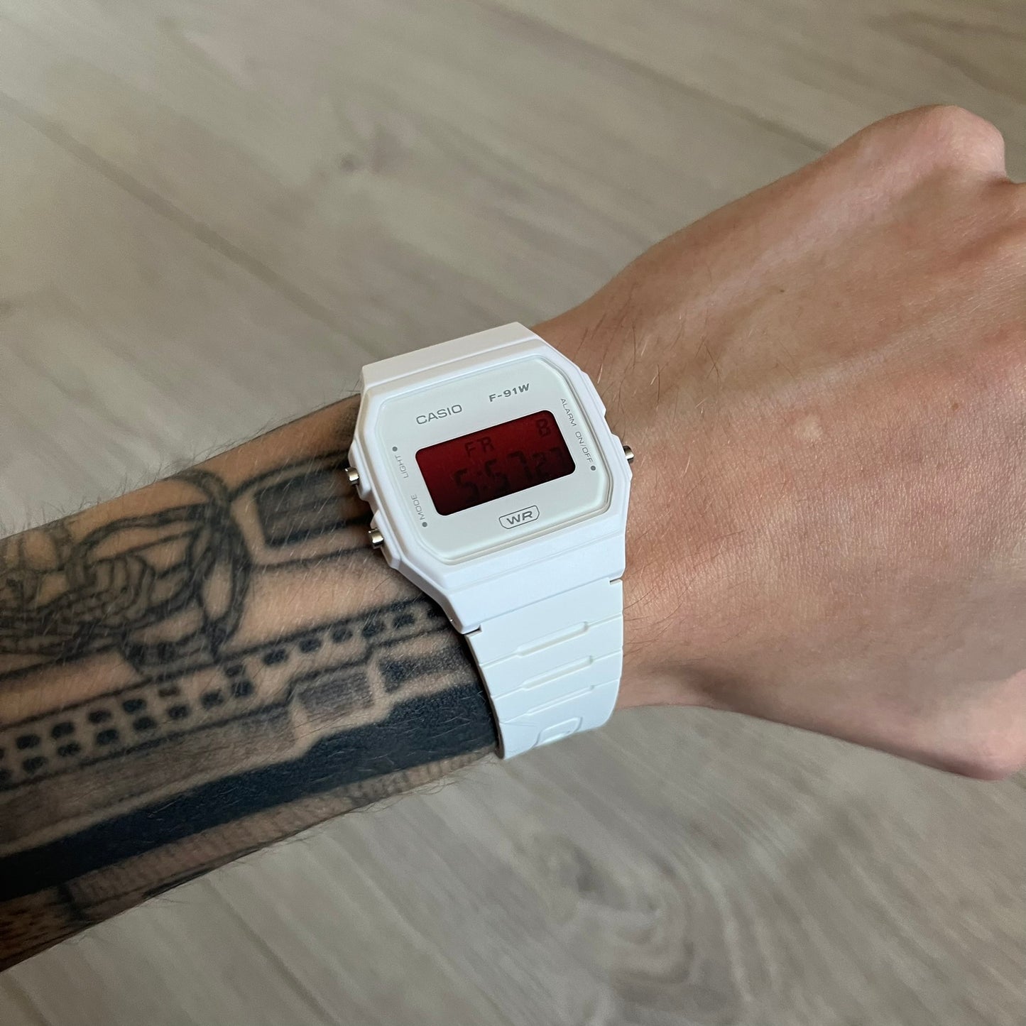 Custom Casio F-91W White digital watch featuring a Gradient Red filter screen. Slim 8.5 mm profile, lightweight 21 g build and flexible bio-based resin band ensure lasting comfort. Includes alarm, stopwatch, and microlight function for everyday functionality.