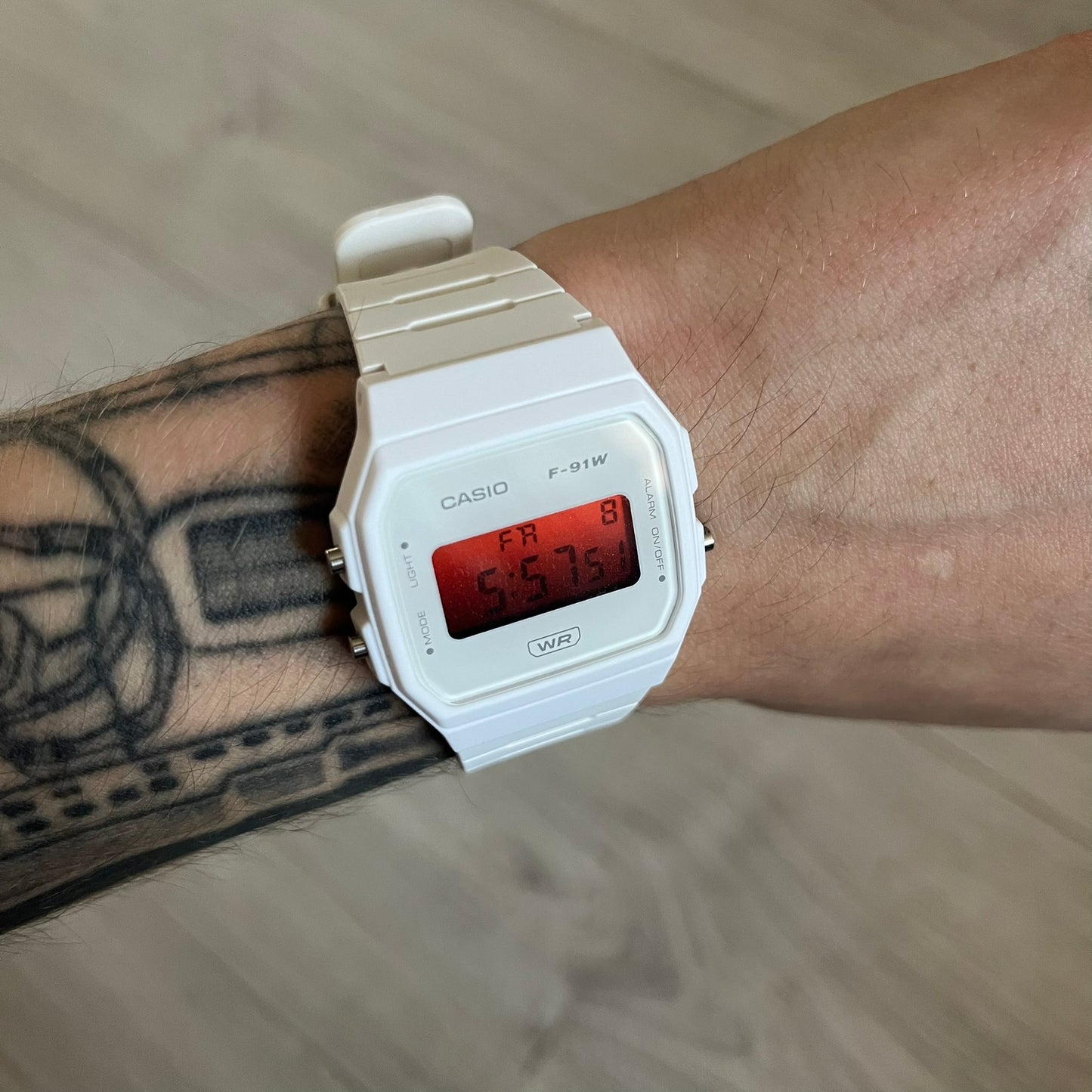 Custom Casio F-91W White digital watch featuring a Gradient Red filter screen. Slim 8.5 mm profile, lightweight 21 g build and flexible bio-based resin band ensure lasting comfort. Includes alarm, stopwatch, and microlight function for everyday functionality.