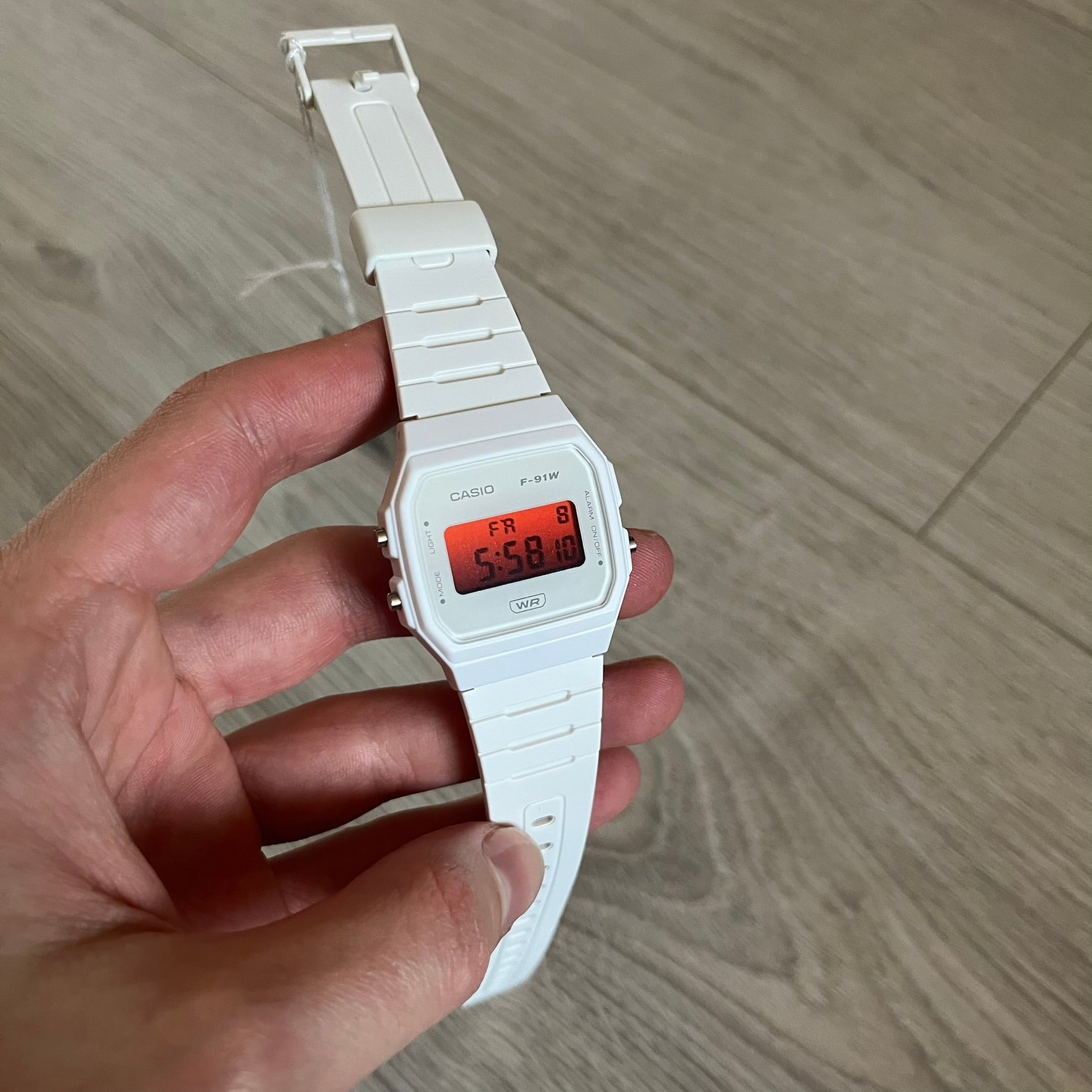 Custom Casio F-91W White digital watch featuring a Gradient Red filter screen. Slim 8.5 mm profile, lightweight 21 g build and flexible bio-based resin band ensure lasting comfort. Includes alarm, stopwatch, and microlight function for everyday functionality.
