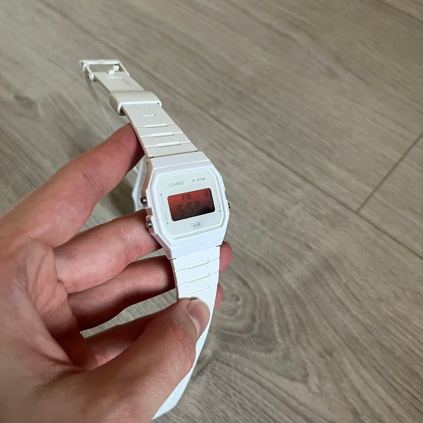 Custom Casio F-91W White digital watch featuring a Gradient Red filter screen. Slim 8.5 mm profile, lightweight 21 g build and flexible bio-based resin band ensure lasting comfort. Includes alarm, stopwatch, and microlight function for everyday functionality.