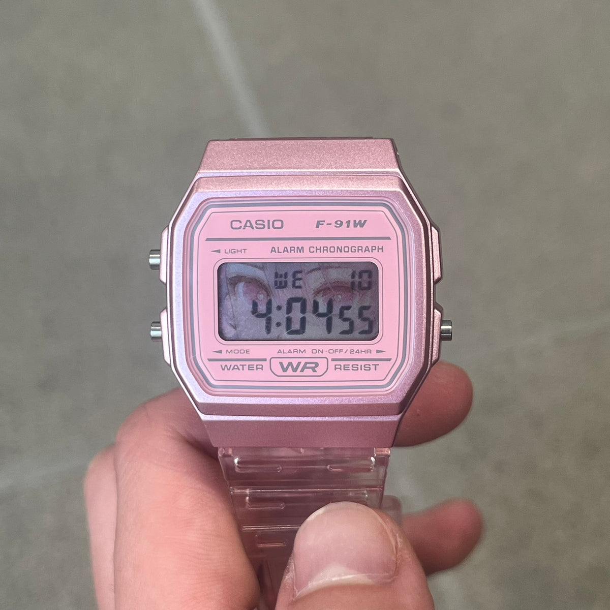 Custom Casio F-91W Pink digital watch featuring a Anime Eyes filter screen. Slim 8.5 mm profile, lightweight 21 g build and flexible bio-based resin band ensure lasting comfort. Includes alarm, stopwatch, and microlight function for everyday functionality.