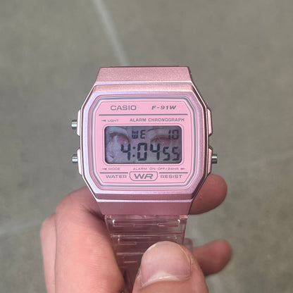 Custom Casio F-91W Pink digital watch featuring a Anime Eyes filter screen. Slim 8.5 mm profile, lightweight 21 g build and flexible bio-based resin band ensure lasting comfort. Includes alarm, stopwatch, and microlight function for everyday functionality.