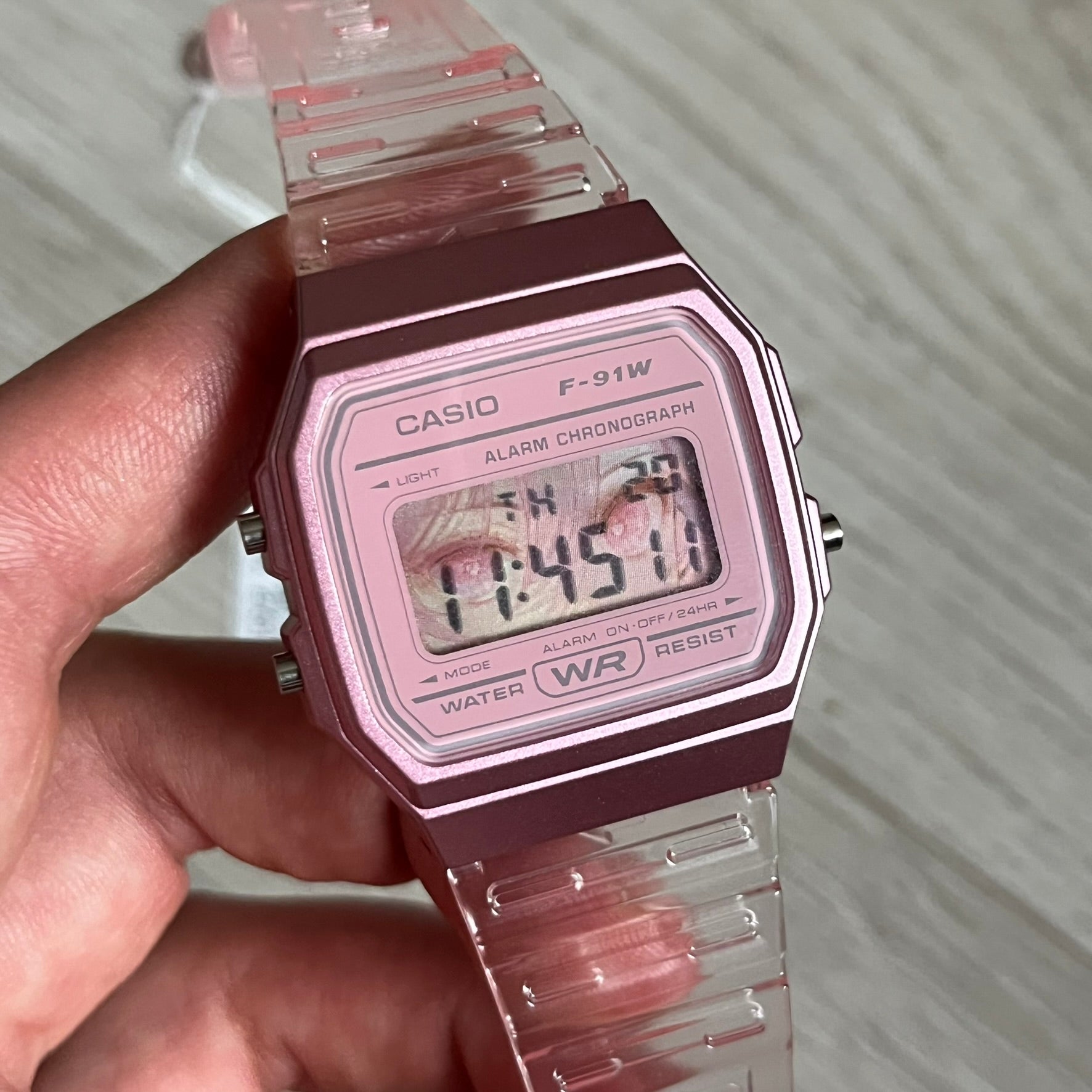 Custom Casio F-91W Pink digital watch featuring a Anime Eyes filter screen. Slim 8.5 mm profile, lightweight 21 g build and flexible bio-based resin band ensure lasting comfort. Includes alarm, stopwatch, and microlight function for everyday functionality.