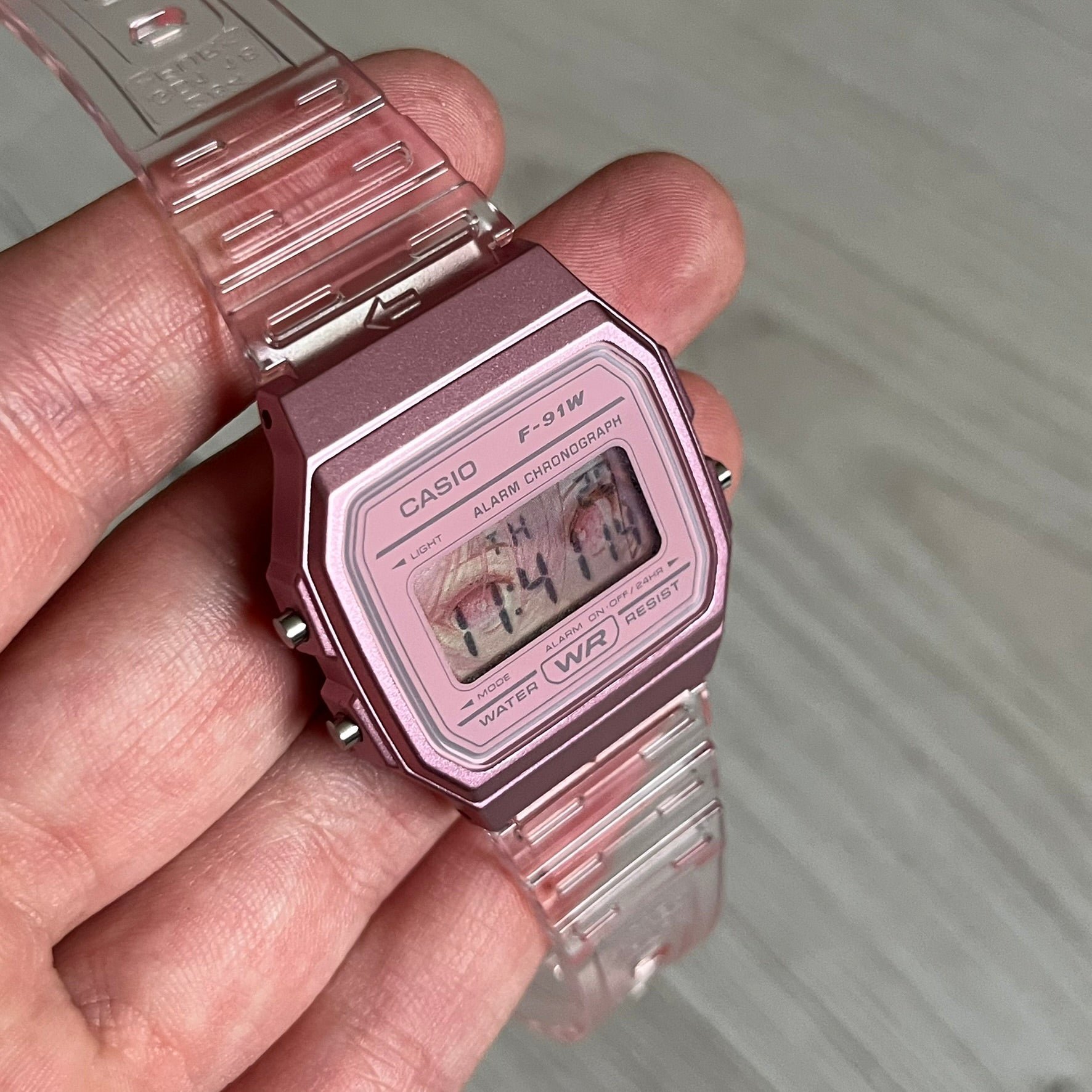 Custom Casio F-91W Pink digital watch featuring a Anime Eyes filter screen. Slim 8.5 mm profile, lightweight 21 g build and flexible bio-based resin band ensure lasting comfort. Includes alarm, stopwatch, and microlight function for everyday functionality.