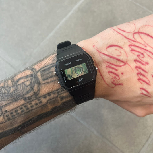 Custom Casio F-91W Black digital watch featuring a Anime green eyes filter screen. Slim 8.5 mm profile, lightweight 21 g build and flexible bio-based resin band ensure lasting comfort. Includes alarm, stopwatch, and microlight function for everyday functionality.