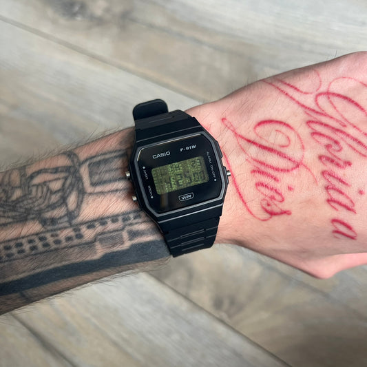 Custom Casio F-91W Black digital watch featuring a Matrix green numbers filter screen. Slim 8.5 mm profile, lightweight 21 g build and flexible bio-based resin band ensure lasting comfort. Includes alarm, stopwatch, and microlight function for everyday functionality.