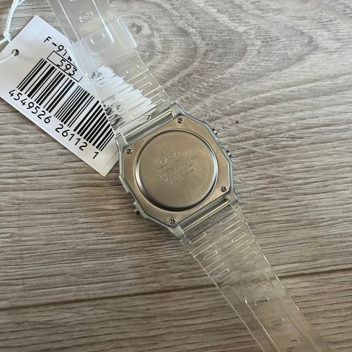 Custom Casio F-91W Clear/Transparent digital watch featuring a Money graphic filter screen. Slim 8.5 mm profile, lightweight 21 g build and flexible bio-based resin band ensure lasting comfort. Includes alarm, stopwatch, and microlight function for everyday functionality.