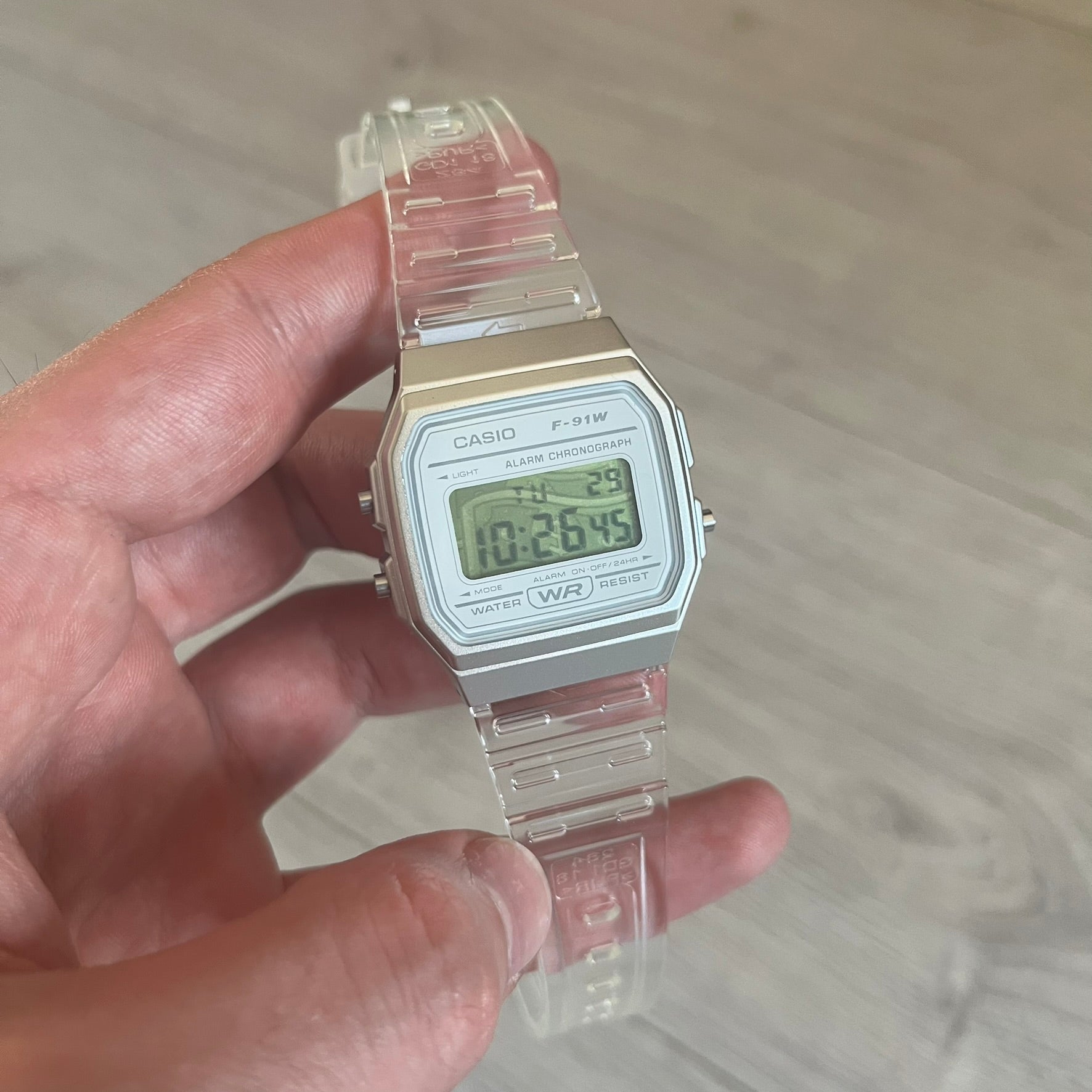 Custom Casio F-91W Clear/Transparent digital watch featuring a Money graphic filter screen. Slim 8.5 mm profile, lightweight 21 g build and flexible bio-based resin band ensure lasting comfort. Includes alarm, stopwatch, and microlight function for everyday functionality.