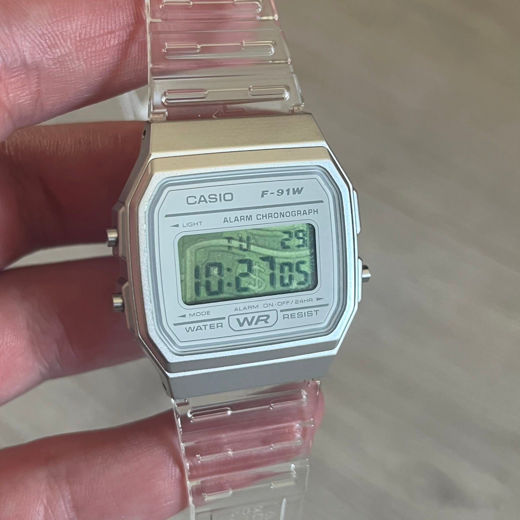 Custom Casio F-91W Clear/Transparent digital watch featuring a Money graphic filter screen. Slim 8.5 mm profile, lightweight 21 g build and flexible bio-based resin band ensure lasting comfort. Includes alarm, stopwatch, and microlight function for everyday functionality.