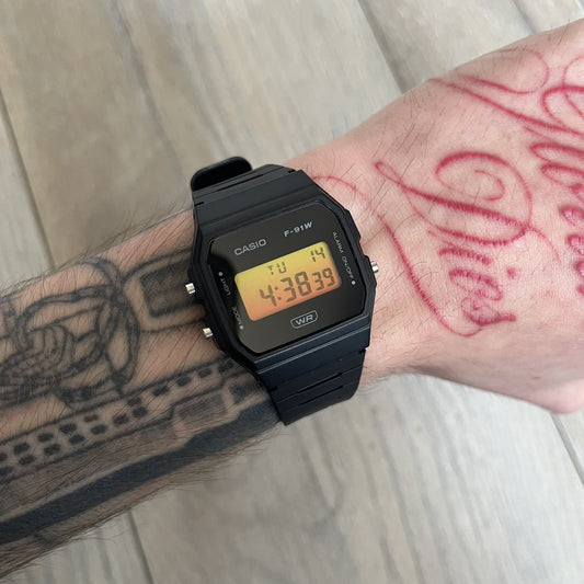 Custom Casio F-91W Black digital watch featuring a Gradient Yellow &amp; Orange filter screen. Slim 8.5 mm profile, lightweight 21 g build and flexible bio-based resin band ensure lasting comfort. Includes alarm, stopwatch, and microlight function for everyday functionality.