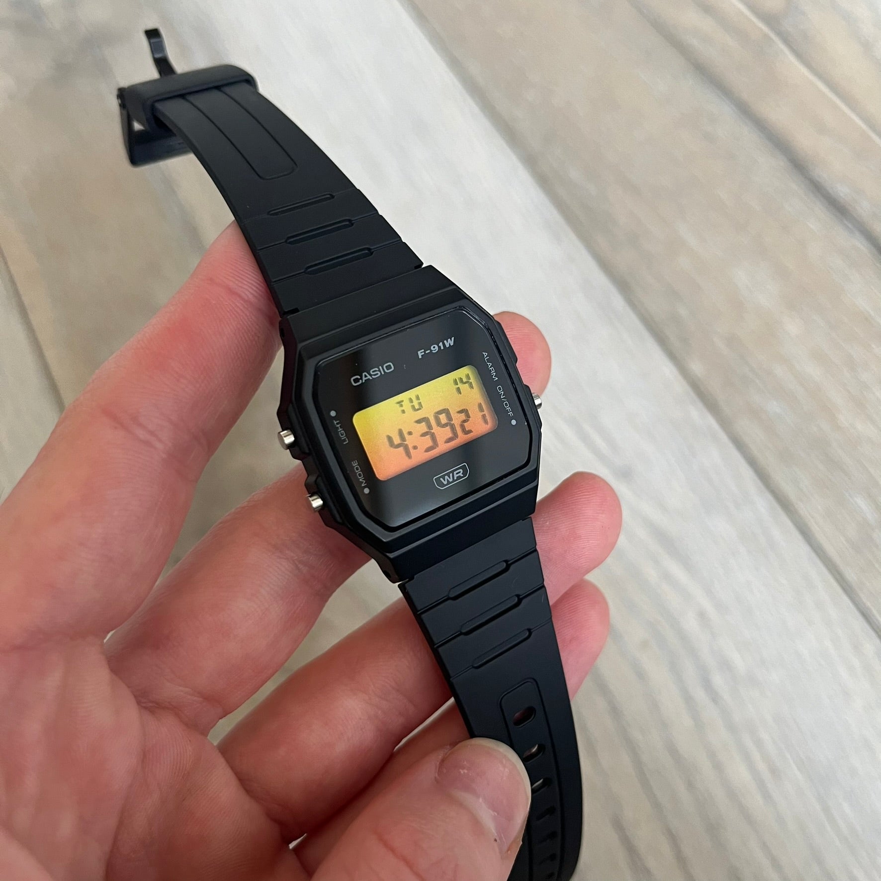 Custom Casio F-91W Black digital watch featuring a Gradient Yellow &amp; Orange filter screen. Slim 8.5 mm profile, lightweight 21 g build and flexible bio-based resin band ensure lasting comfort. Includes alarm, stopwatch, and microlight function for everyday functionality.