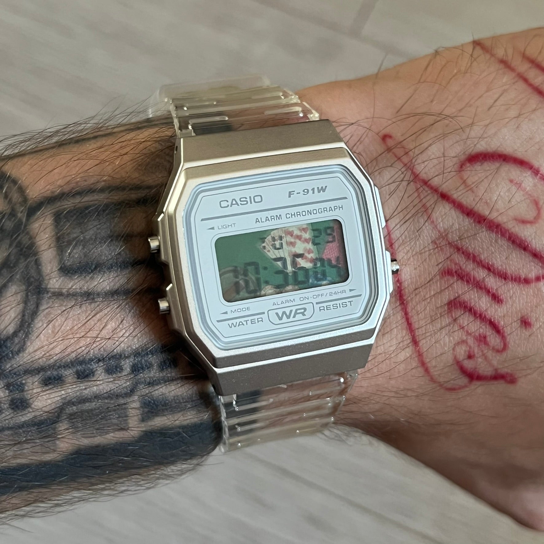 Custom Casio F-91W Clear/Transparent digital watch featuring a Poker table graphic filter screen. Slim 8.5 mm profile, lightweight 21 g build and flexible bio-based resin band ensure lasting comfort. Includes alarm, stopwatch, and microlight function for everyday functionality.