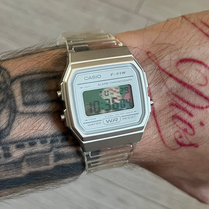 Custom Casio F-91W Clear/Transparent digital watch featuring a Poker table graphic filter screen. Slim 8.5 mm profile, lightweight 21 g build and flexible bio-based resin band ensure lasting comfort. Includes alarm, stopwatch, and microlight function for everyday functionality.