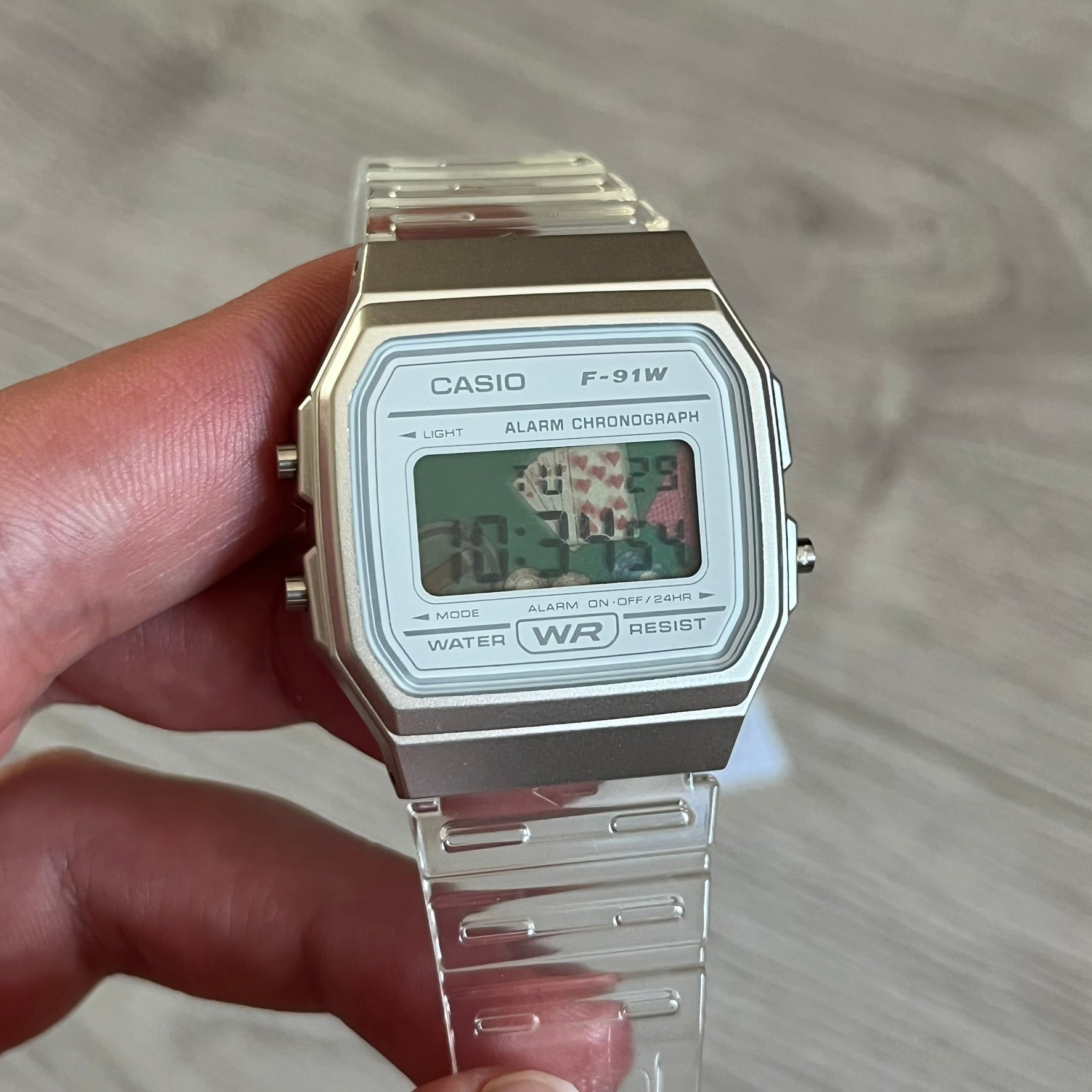 Custom Casio F-91W Clear/Transparent digital watch featuring a Poker table graphic filter screen. Slim 8.5 mm profile, lightweight 21 g build and flexible bio-based resin band ensure lasting comfort. Includes alarm, stopwatch, and microlight function for everyday functionality.