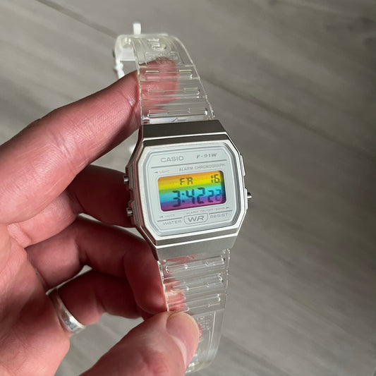 Custom Casio F-91W Clear/Transparent digital watch featuring a rainbow filter screen. Slim 8.5 mm profile, lightweight 21 g build and flexible bio-based resin band ensure lasting comfort. Includes alarm, stopwatch, and microlight function for everyday functionality.