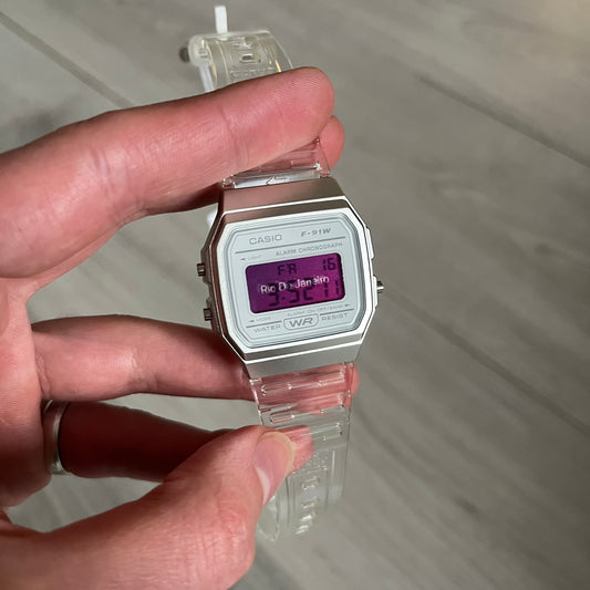 Custom Casio F-91W Clear/Transparent digital watch featuring a Rio De Janeiro filter screen. Slim 8.5 mm profile, lightweight 21 g build and flexible bio-based resin band ensure lasting comfort. Includes alarm, stopwatch, and microlight function for everyday functionality.