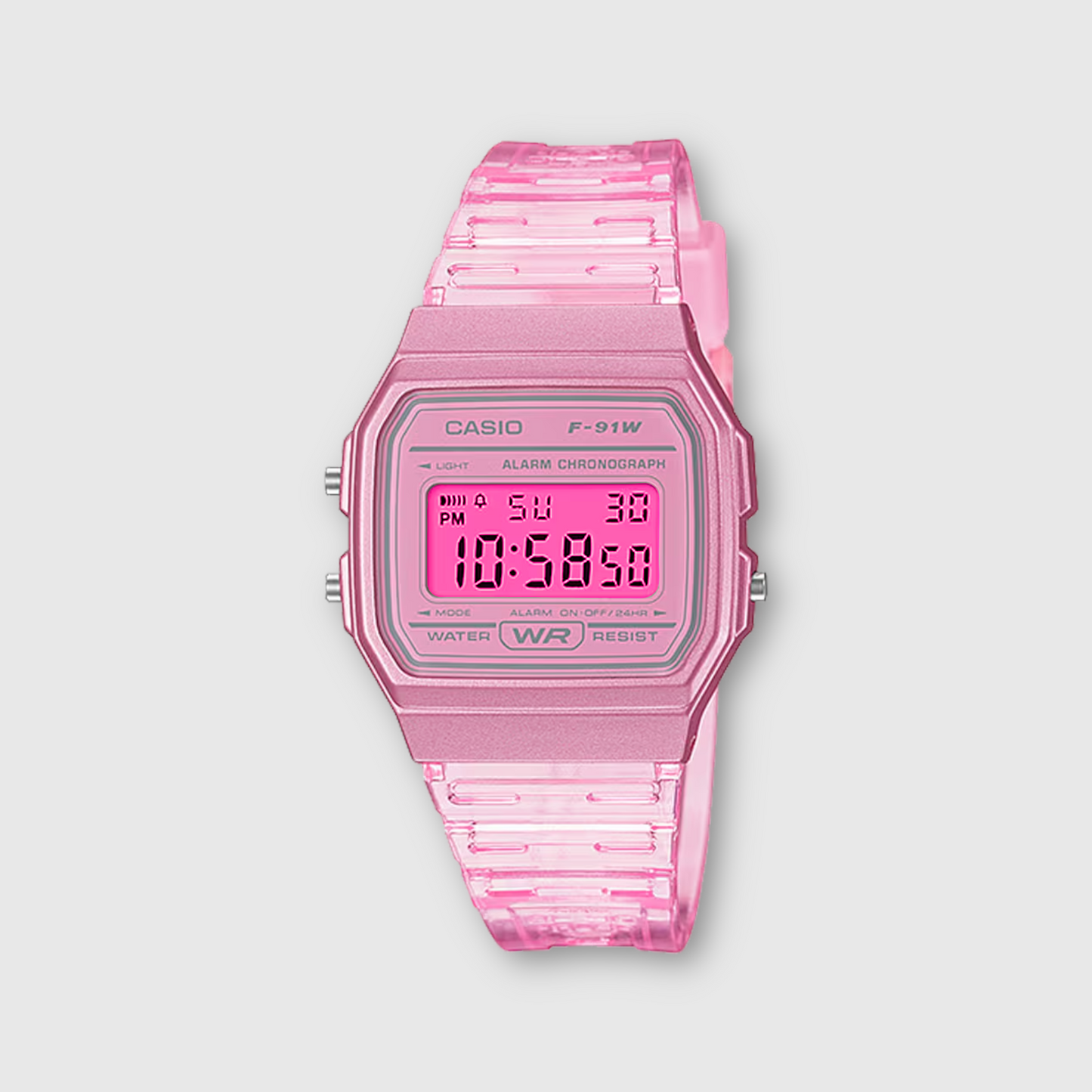 Pink Casio digital watch on a light gray background