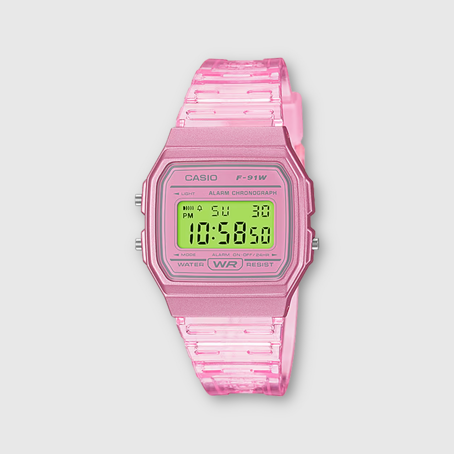 Pink Casio digital watch with a clear strap on a light gray background