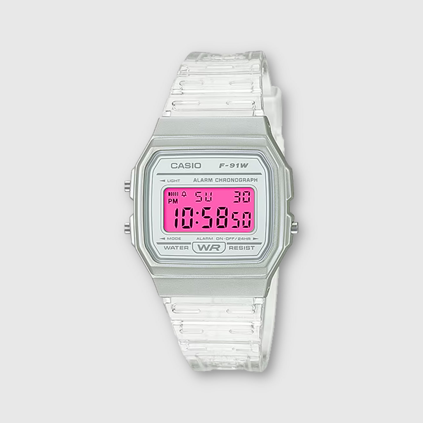 Casio digital watch with pink display on a light gray background