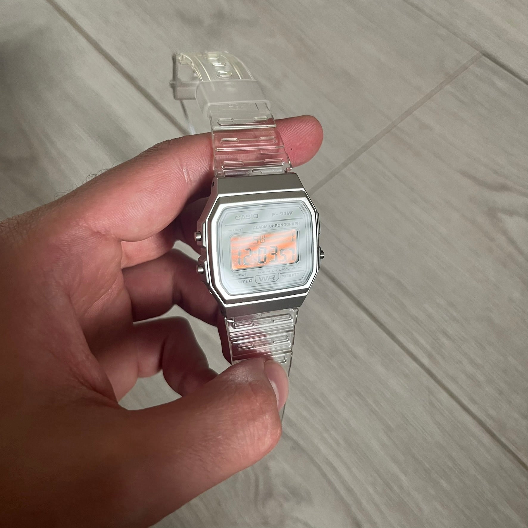Custom Casio F-91W Clear/Transparent digital watch featuring a Silver reflective filter screen. Slim 8.5 mm profile, lightweight 21 g build and flexible bio-based resin band ensure lasting comfort. Includes alarm, stopwatch, and microlight function for everyday functionality.