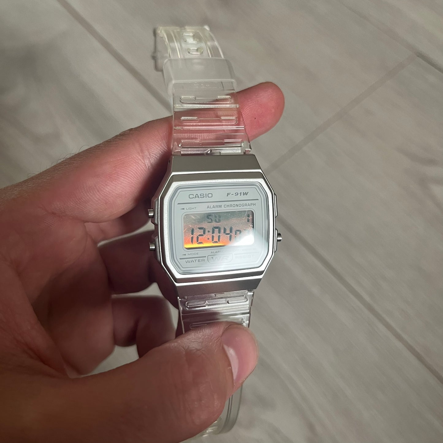 Custom Casio F-91W Clear/Transparent digital watch featuring a Silver reflective filter screen. Slim 8.5 mm profile, lightweight 21 g build and flexible bio-based resin band ensure lasting comfort. Includes alarm, stopwatch, and microlight function for everyday functionality.