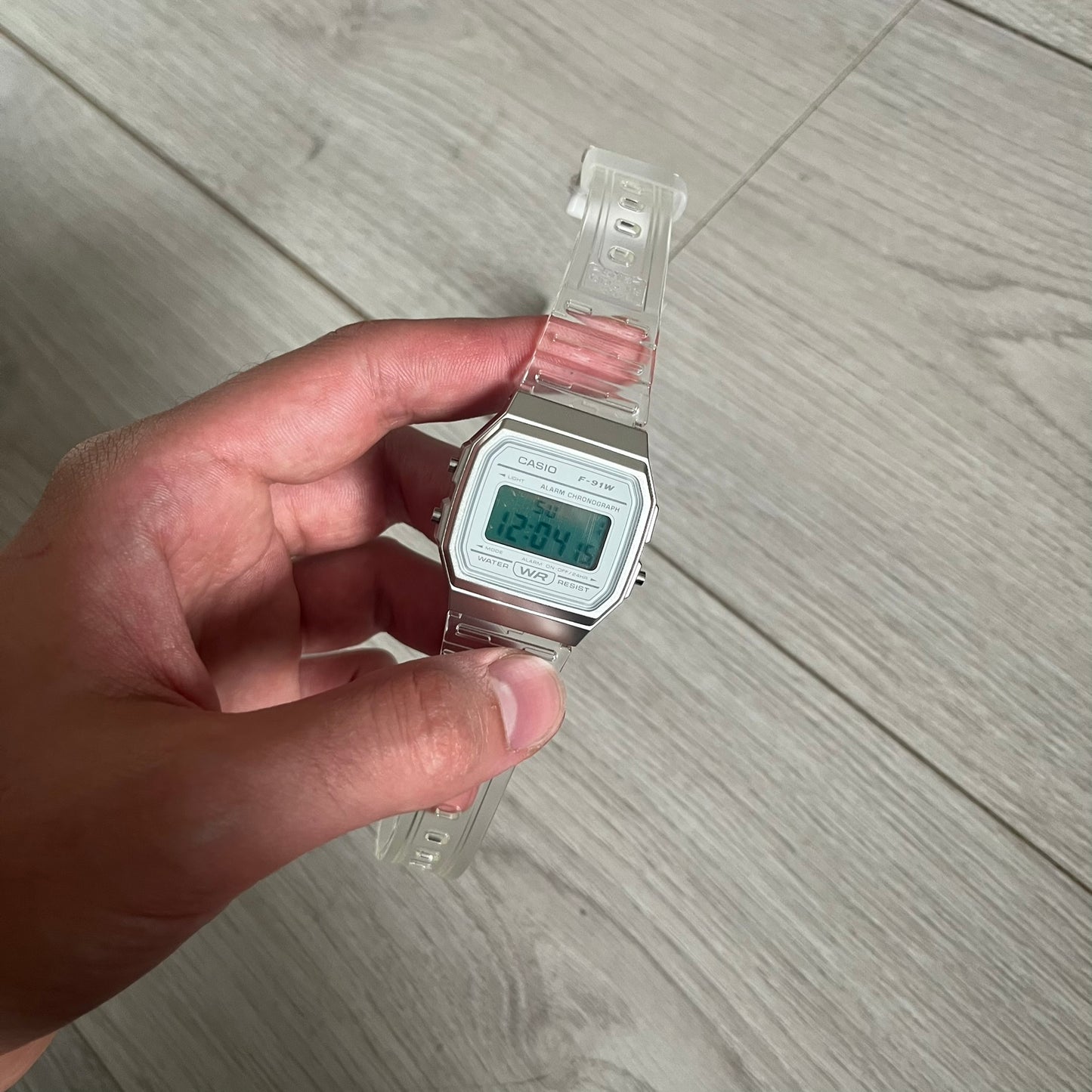 Custom Casio F-91W Clear/Transparent digital watch featuring a Silver reflective filter screen. Slim 8.5 mm profile, lightweight 21 g build and flexible bio-based resin band ensure lasting comfort. Includes alarm, stopwatch, and microlight function for everyday functionality.
