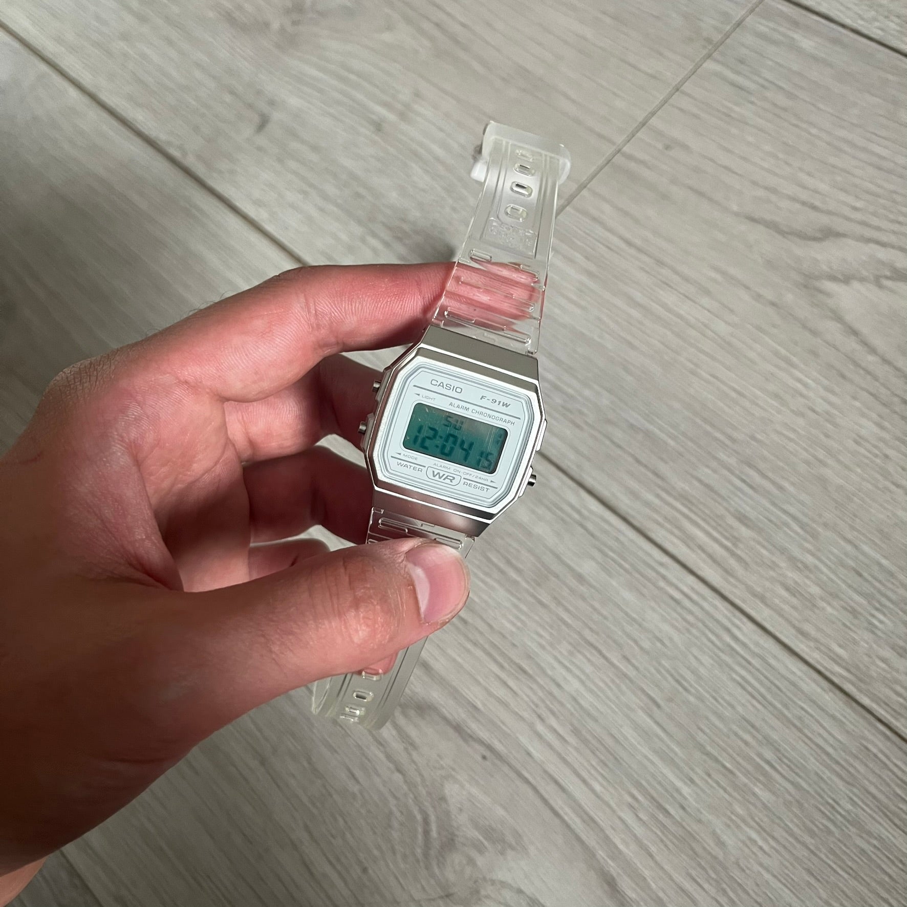 Custom Casio F-91W Clear/Transparent digital watch featuring a Silver reflective filter screen. Slim 8.5 mm profile, lightweight 21 g build and flexible bio-based resin band ensure lasting comfort. Includes alarm, stopwatch, and microlight function for everyday functionality.