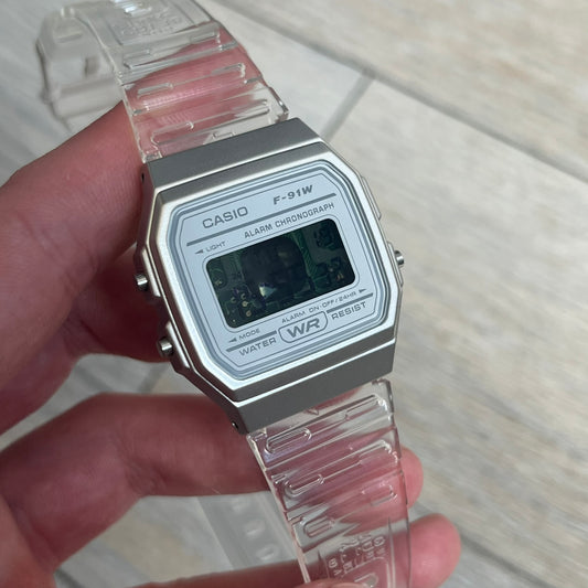 Custom Casio F-91W Clear/Transparent digital watch featuring a see through/clear filter screen. Slim 8.5 mm profile, lightweight 21 g build and flexible bio-based resin band ensure lasting comfort. Includes alarm, stopwatch, and microlight function for everyday functionality.